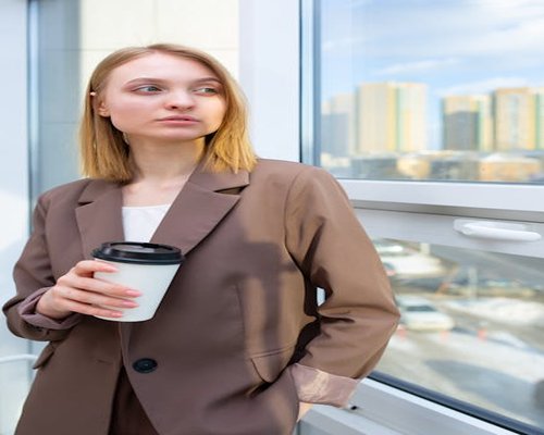 Person looking through office window during work break