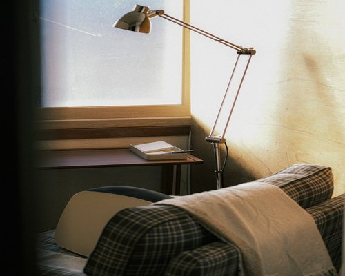 Comfortable reading setup with warm side lamp and open book