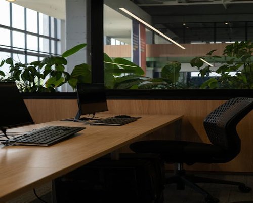 Modern open office workspace with screens and natural light in Indonesia